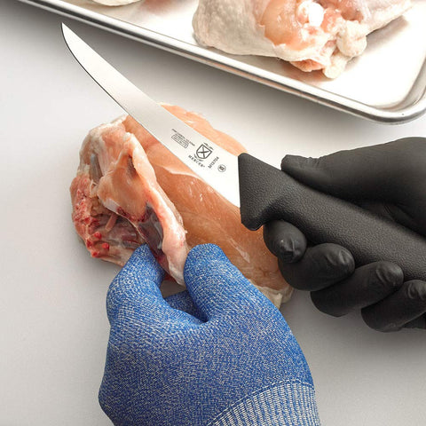 Mercer BPX deboning chicken with curved blade allows delicate cuts.