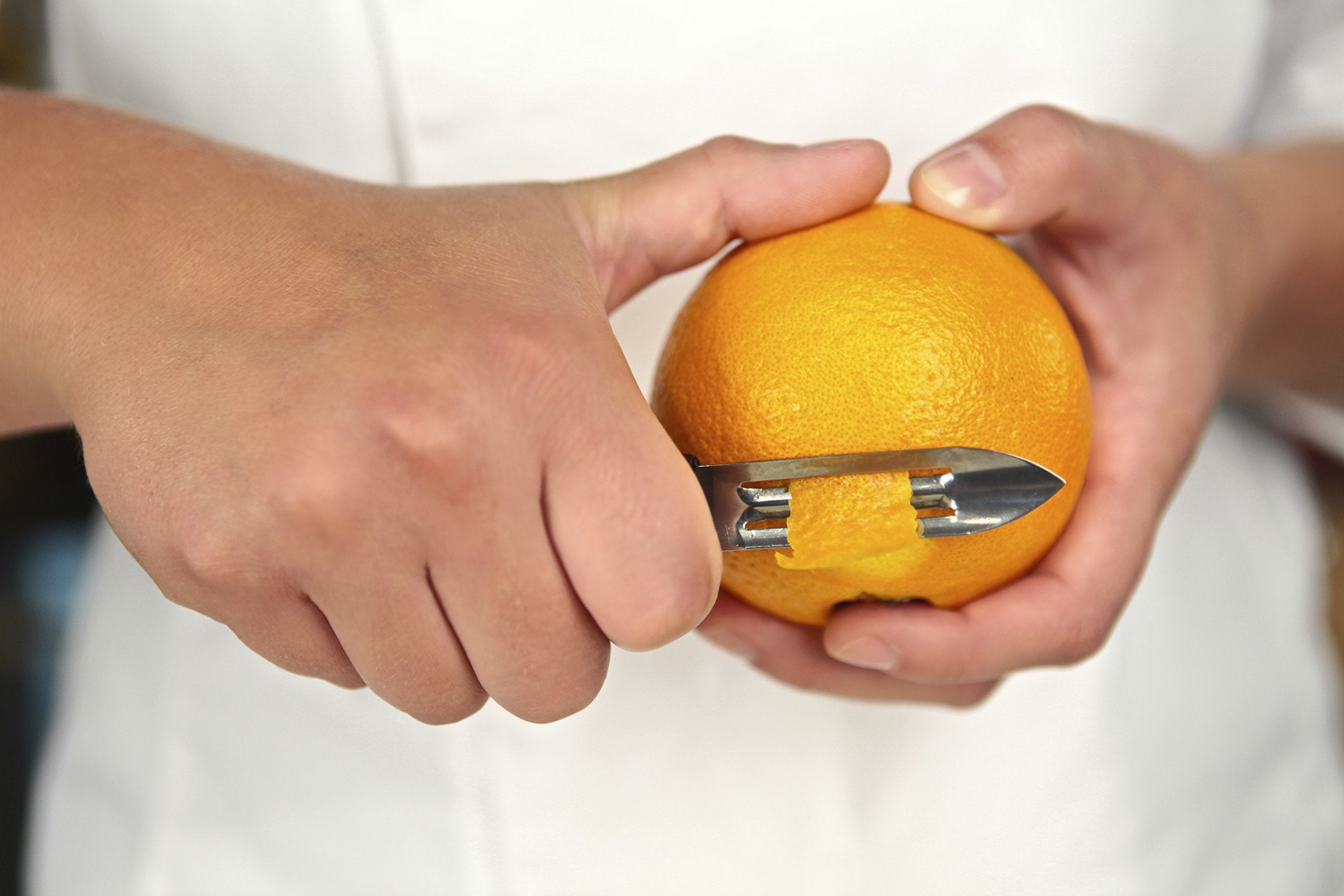 Mercer Culinary vegetable peeler in action demonstrates efficient peeling for garnish-ready produce.