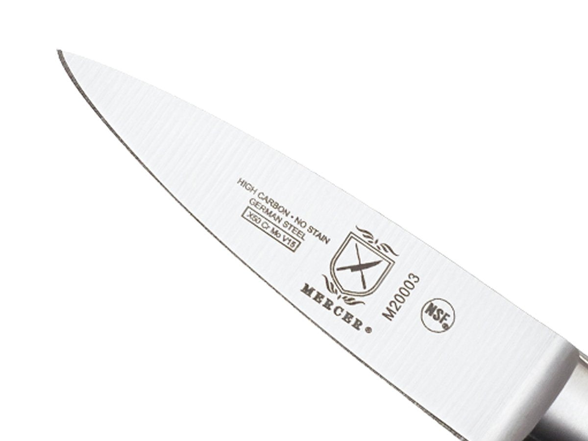 Mercer Culinary Genesis paring knife in hand for precise, controlled small cuts.