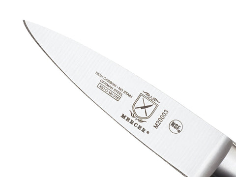 Mercer Culinary Genesis paring knife in hand for precise, controlled small cuts.