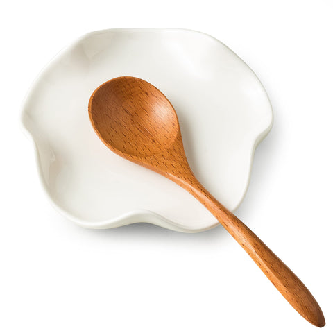 Miamolo spoon rest on stove top catching drips to keep counters clean