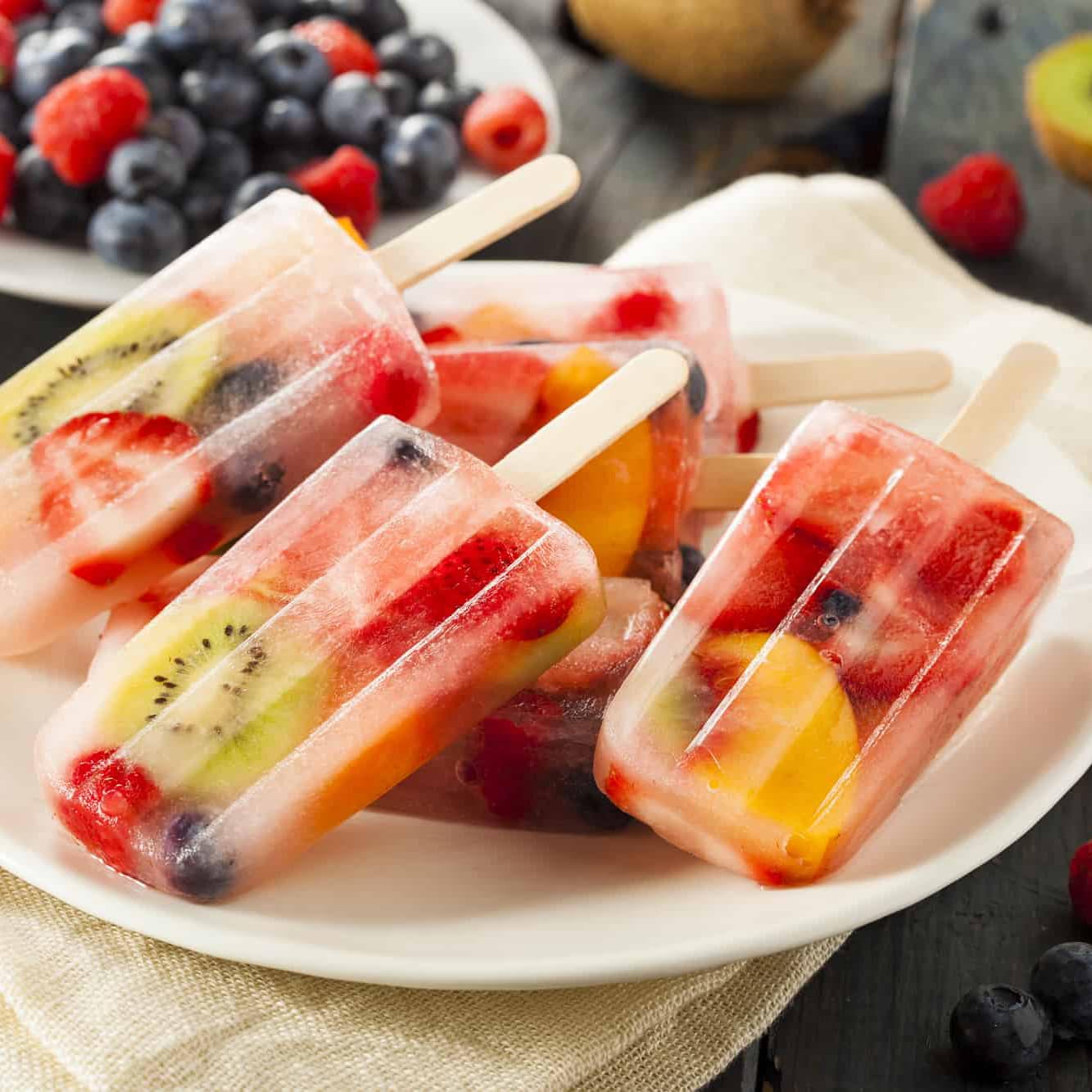Miaowoof molds in use pouring juice to create kid-friendly snacks