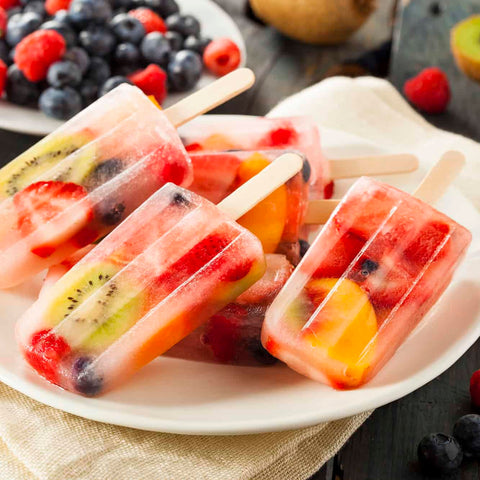 Miaowoof molds in use pouring juice to create kid-friendly snacks