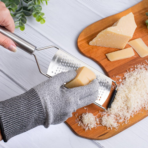 Microplane coarse grater producing cheese shavings with rustic texture.