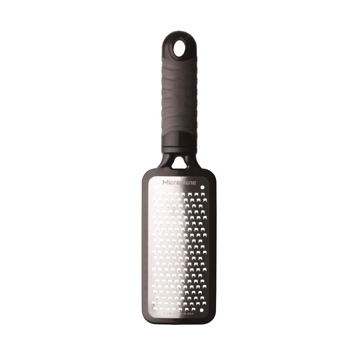 Microplane Home Series grater in use over a bowl producing chunky shreds