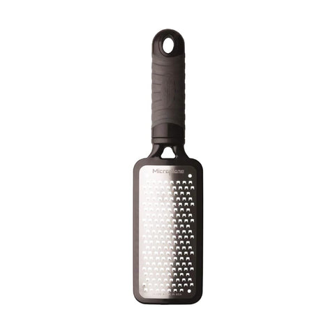 Microplane Home Series grater in use over a bowl producing chunky shreds