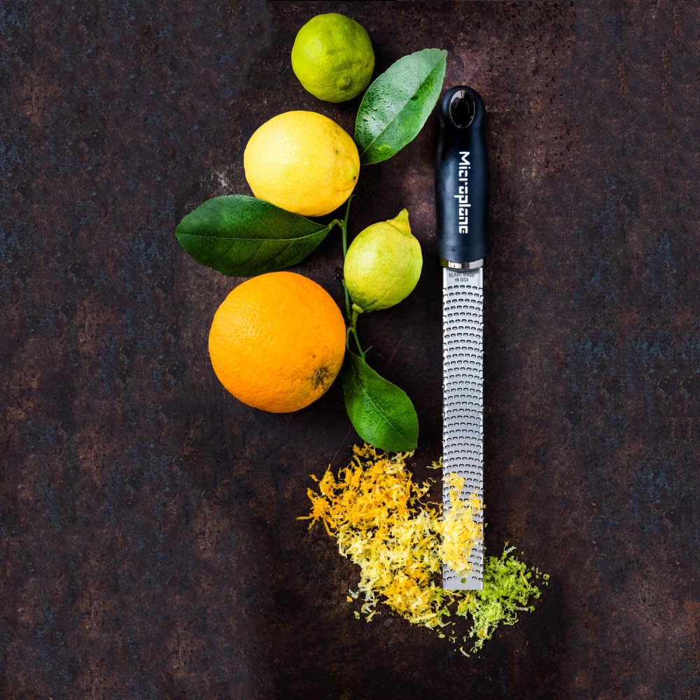Microplane Premium Classic Zester shaving chocolate for dessert garnishes.