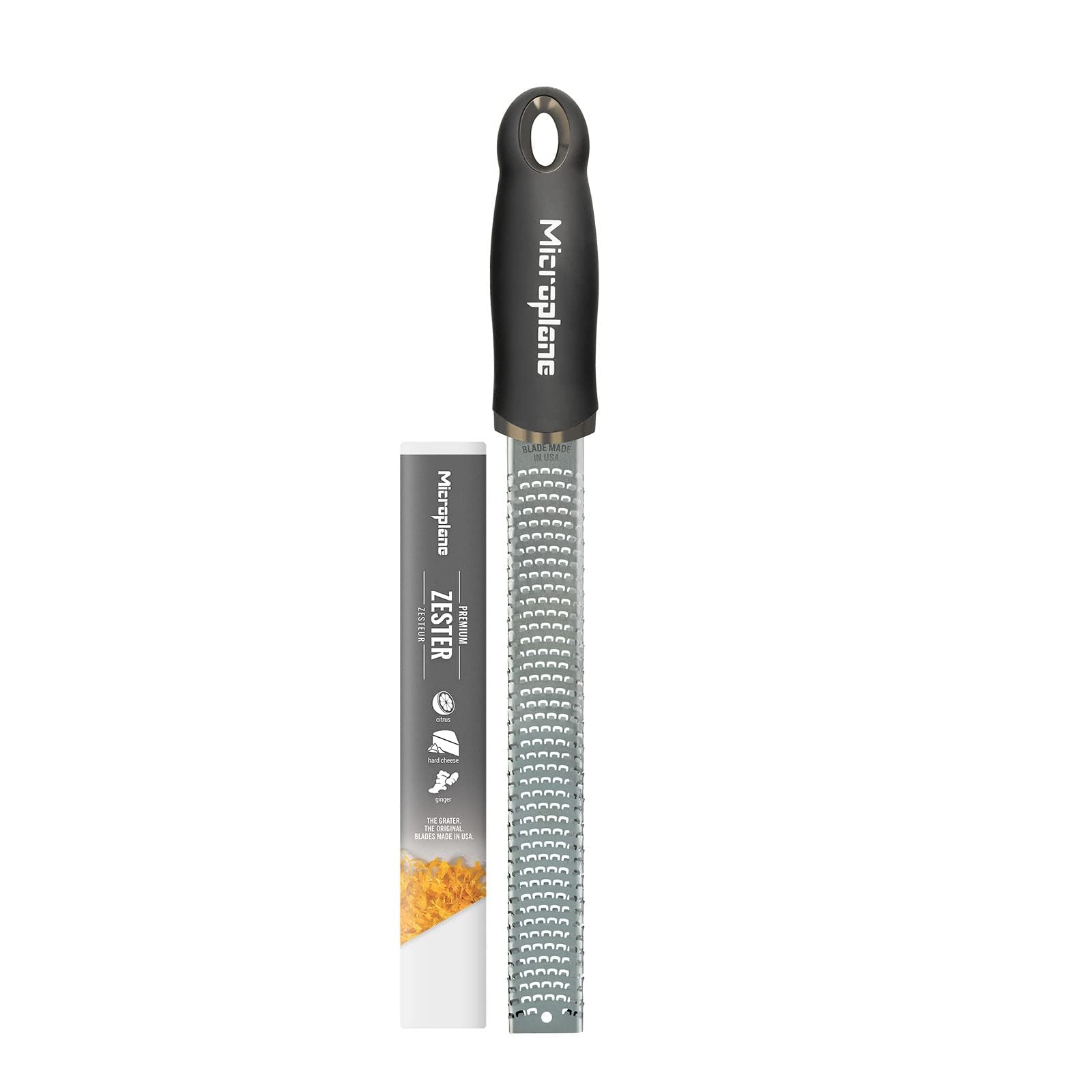 Microplane Premium Classic Zester zesting lemon for bright citrus notes in dressings.