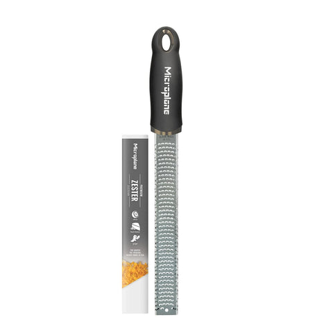 Microplane Premium Classic Zester zesting lemon for bright citrus notes in dressings.