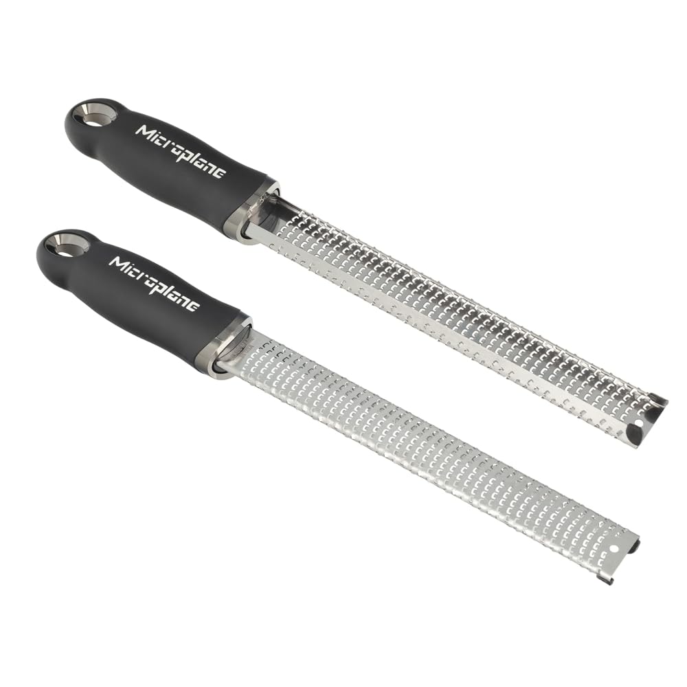 Microplane Premium Classic Zester grating Parmesan for fluffy, melt-quick cheese toppings.
