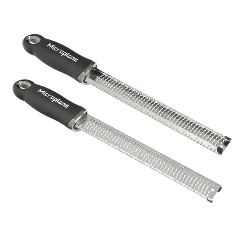 Microplane Premium Classic Zester grating Parmesan for fluffy, melt-quick cheese toppings.