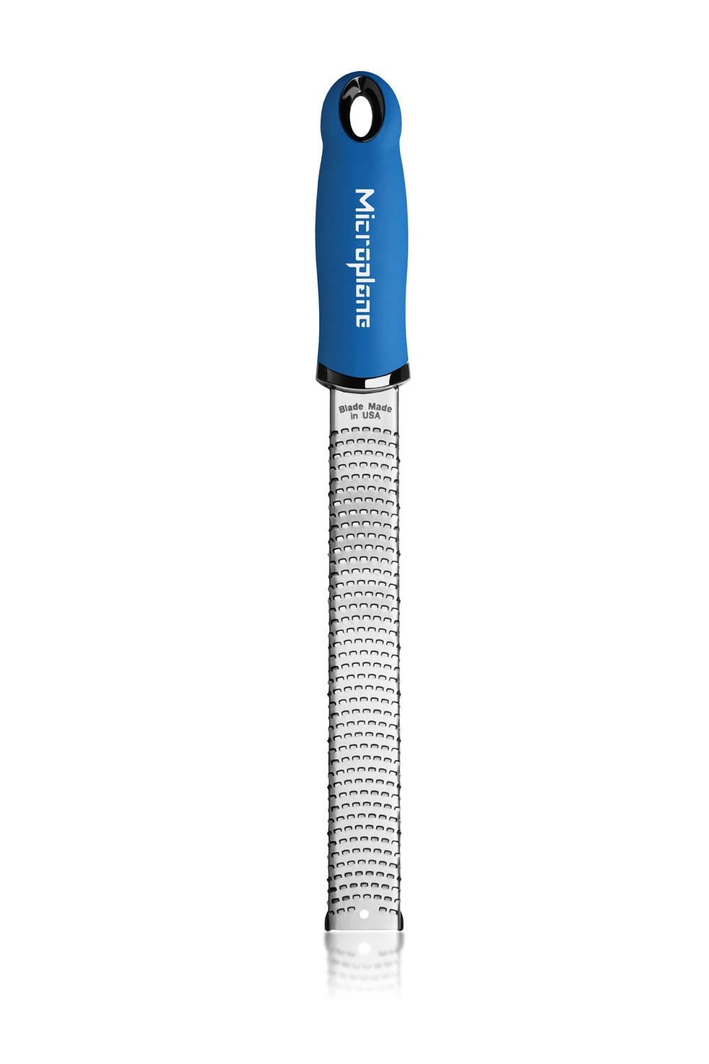 Microplane Premium Classic Zester Blue grating ginger into paste.