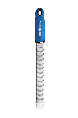 Microplane Premium Classic Zester Blue grating ginger into paste.
