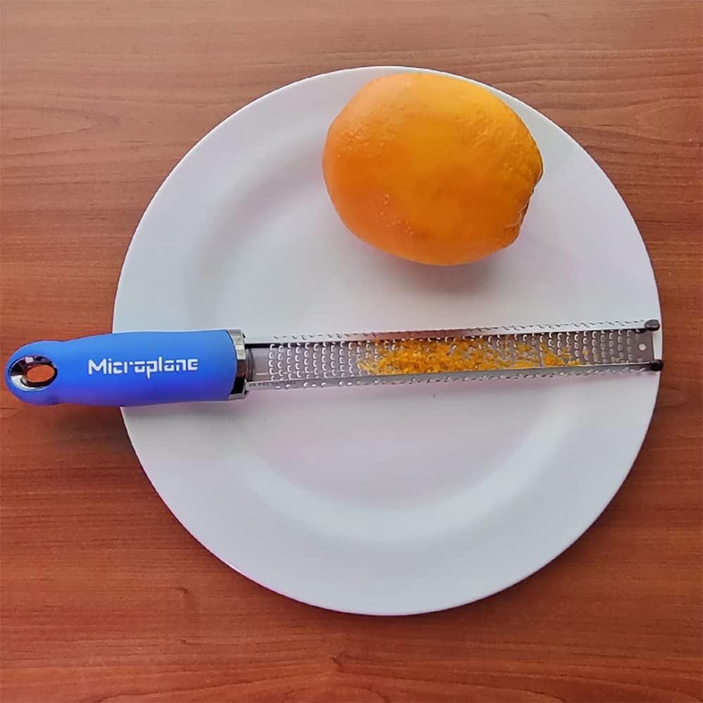 Microplane Premium Classic Zester Blue hangs on a magnetic strip.