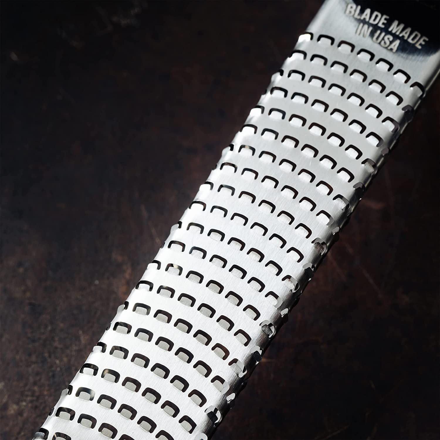 Microplane Premium Classic Zester Grater shredding ginger into a fine paste