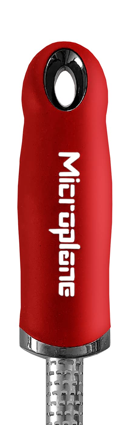 Microplane red spice grater ergonomic handle for comfortable grating sessions.