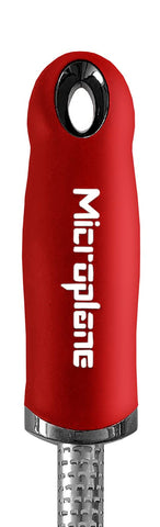 Microplane red spice grater ergonomic handle for comfortable grating sessions.
