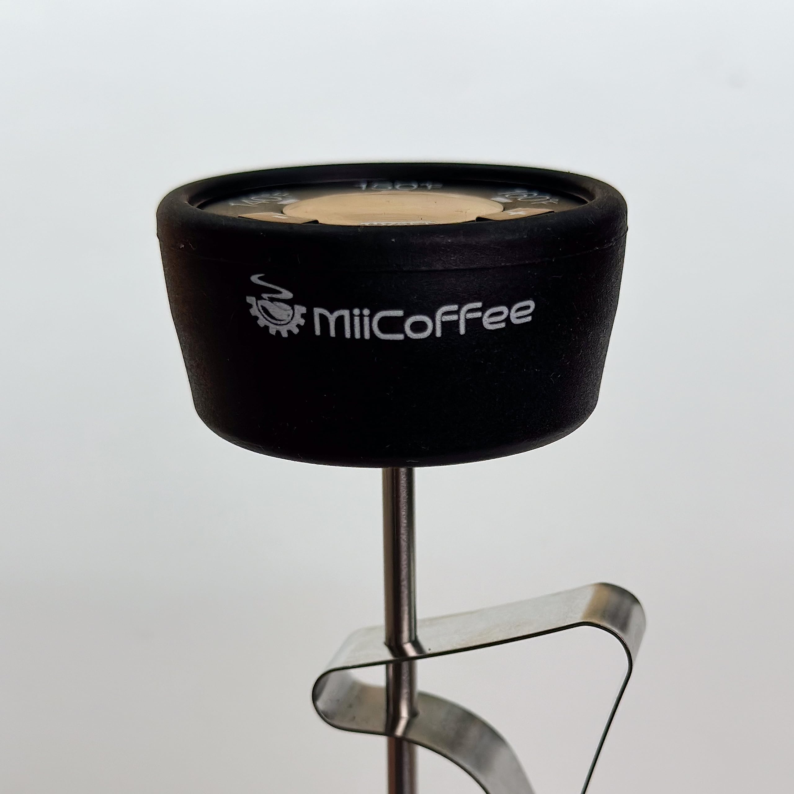 MiiCoffee thermometer in action on espresso milk steam for glossy microfoam.