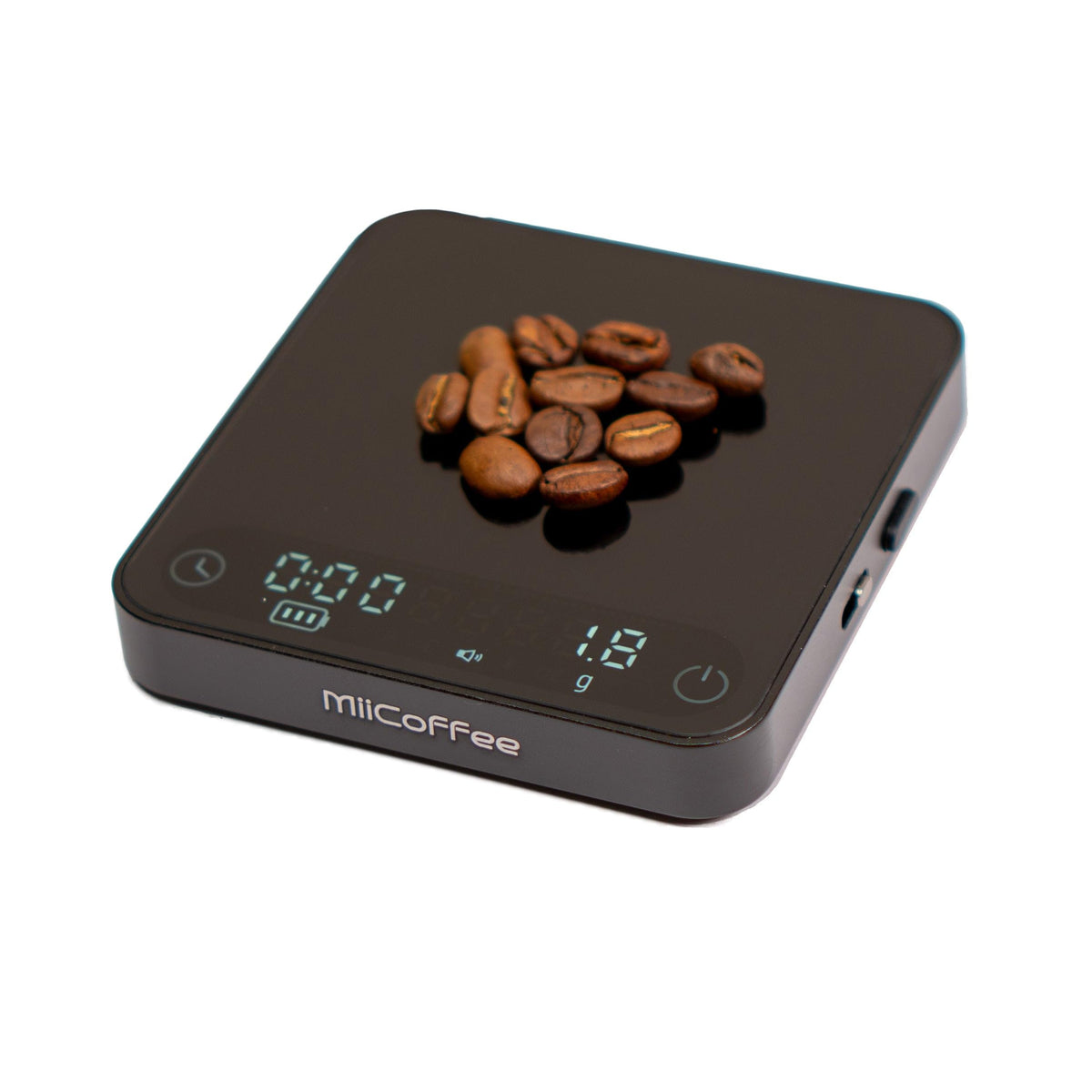 MiiCoffee Minipress palm-size scale beside a compact espresso machine for precise dosing