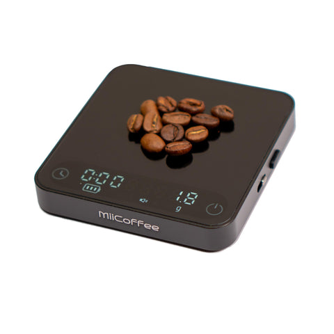MiiCoffee Minipress palm-size scale beside a compact espresso machine for precise dosing