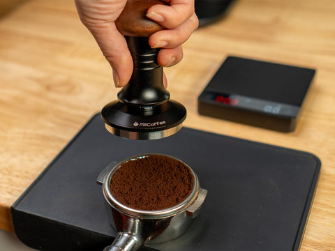 Ergonomic wooden and metal handle for a comfortable grip during tamping.