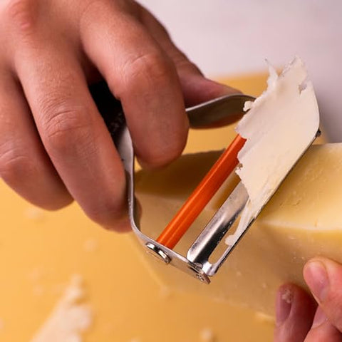 Milk Street Precision Peeler with pivoting blade handles curved vegetables smoothly.