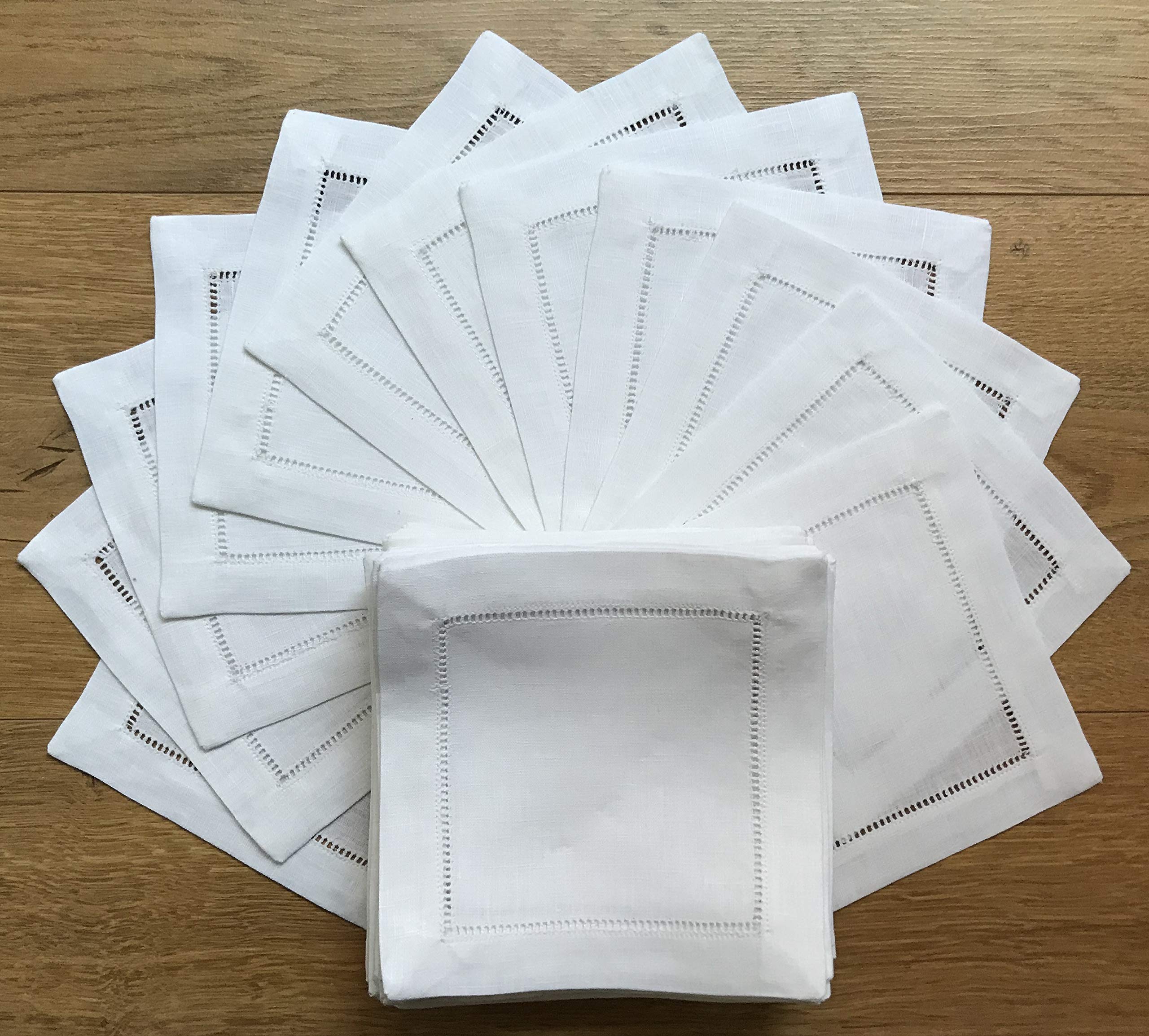 Minhcraft white linen napkins with ladder-hemstitch stacked for elegant service.