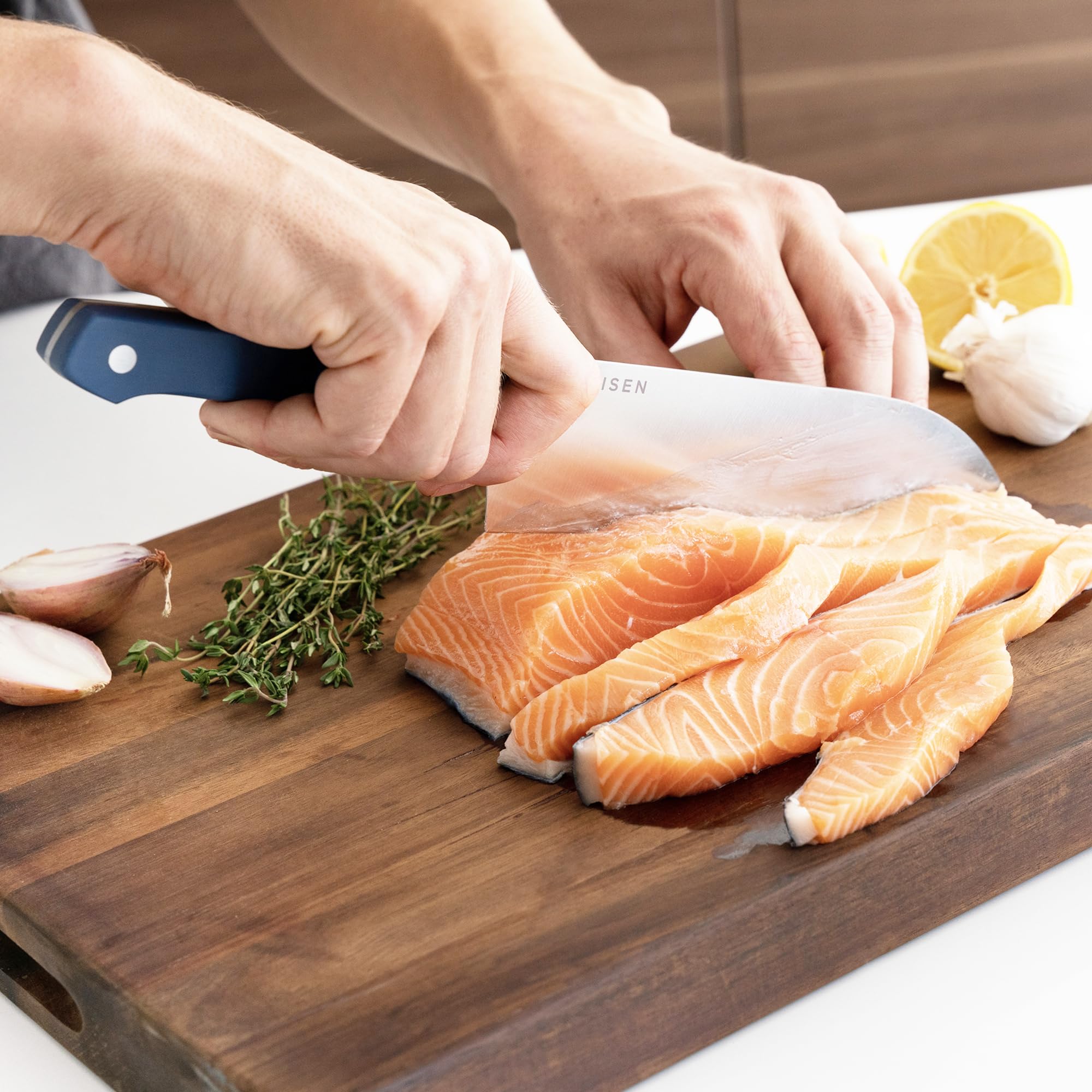 Misen Santoku knife in hand cutting vegetables demonstrates kitchen versatility.