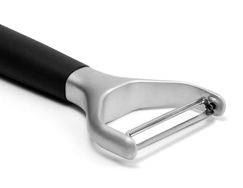 Misen vegetable peeler in hand for quick prep tasks.