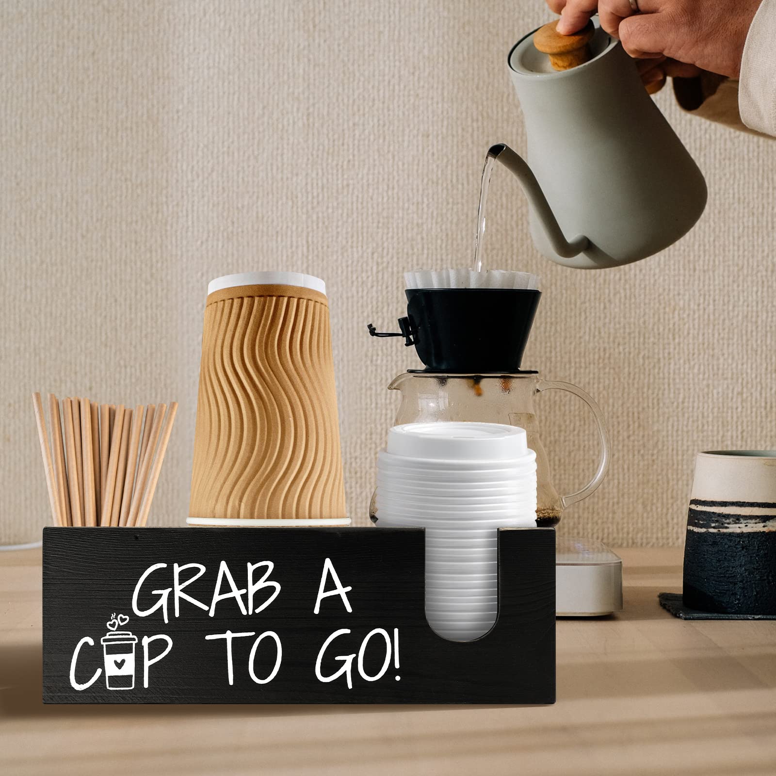 Mistod storage for cups, lids, and stirrers maintains a tidy beverage setup.