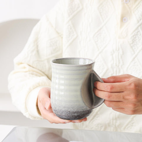 Mkour office-desk setup shows the mug as a productivity-friendly coffee companion