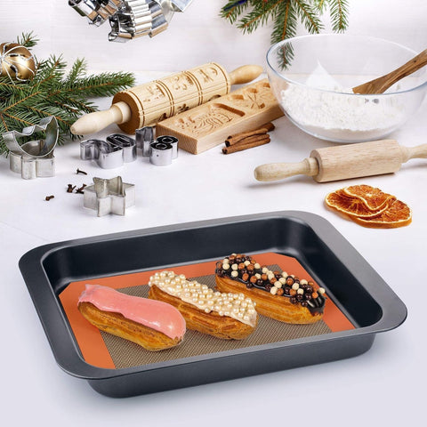 MMMAT silicone baking mat laid flat on pan, reusable surface replacing parchment paper.