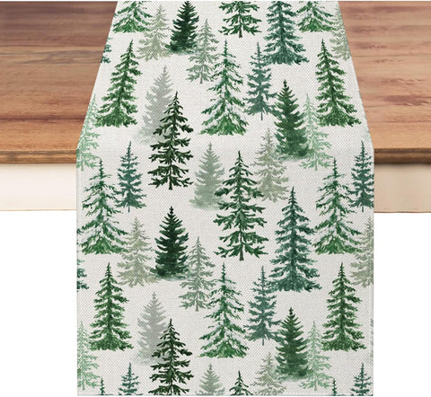 Moutina Christmas runner with green pine trees enhances festive dining.