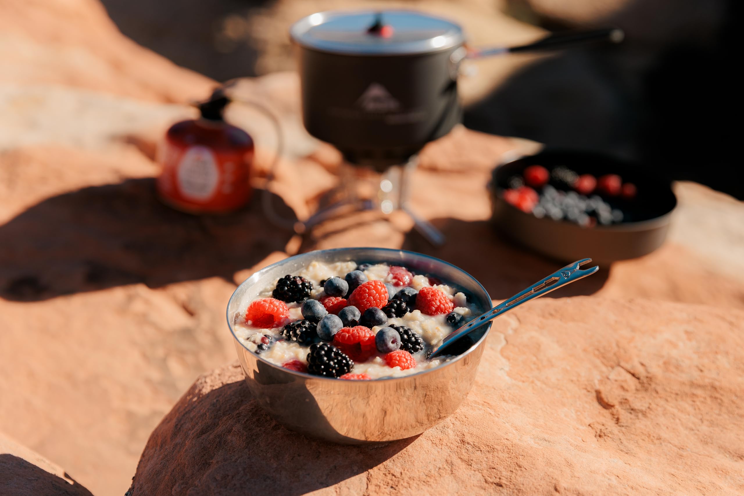 MSR Alpine nesting bowl in a camp kitchen setting, ready for hot meals outdoors.