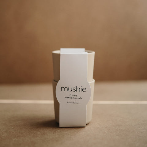 Mushie ivory cups held easily by small hands during meals.