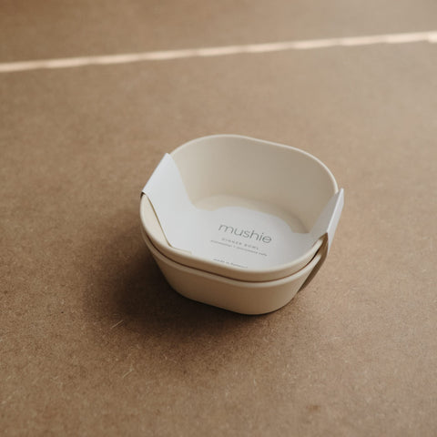 Mushie square dinnerware ivory bowls kid holding demonstrates light weight and easy grip