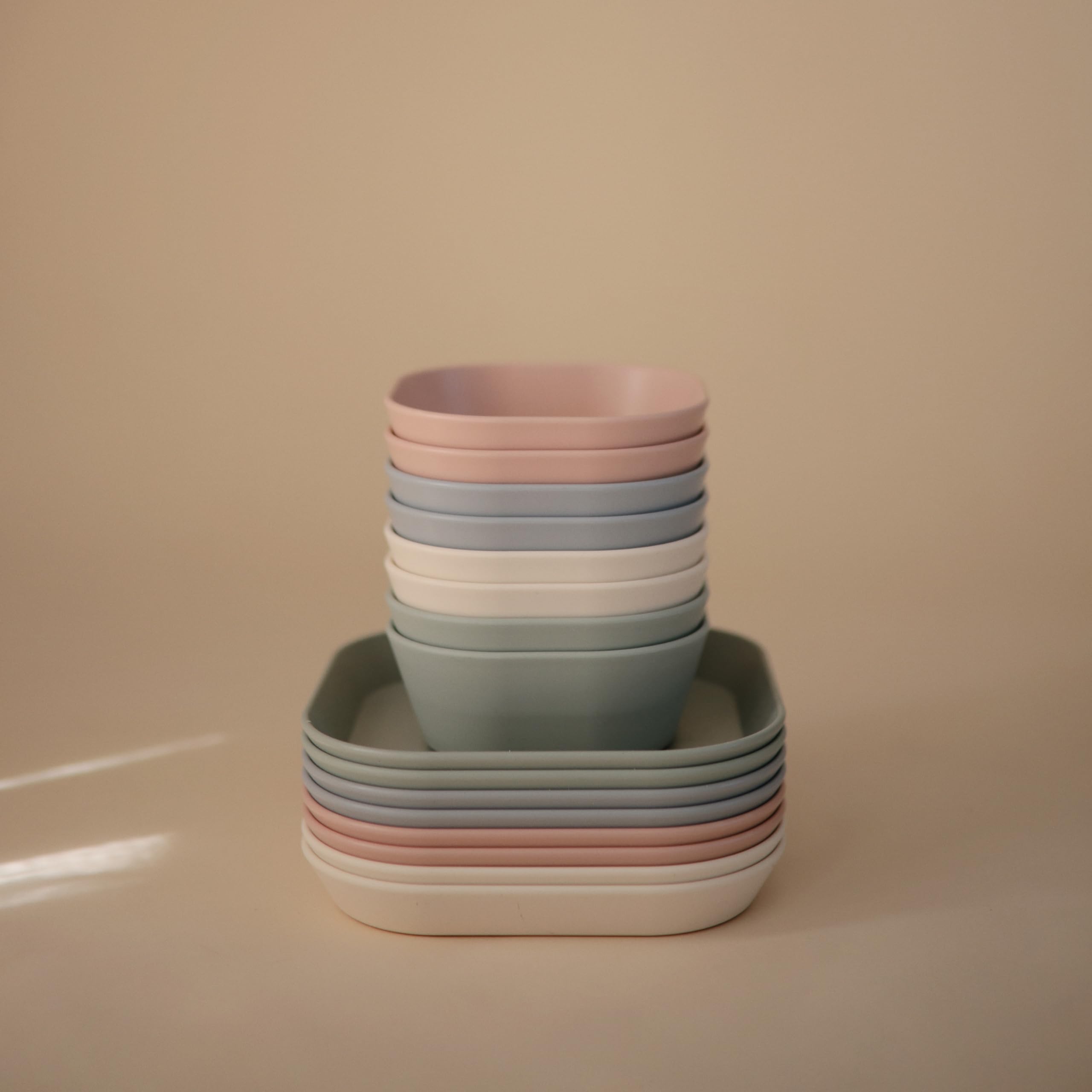Mushie blush plate held by child, ideal for snacks and meals