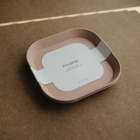 Mushie blush square plate on table, helps steady self-feeding