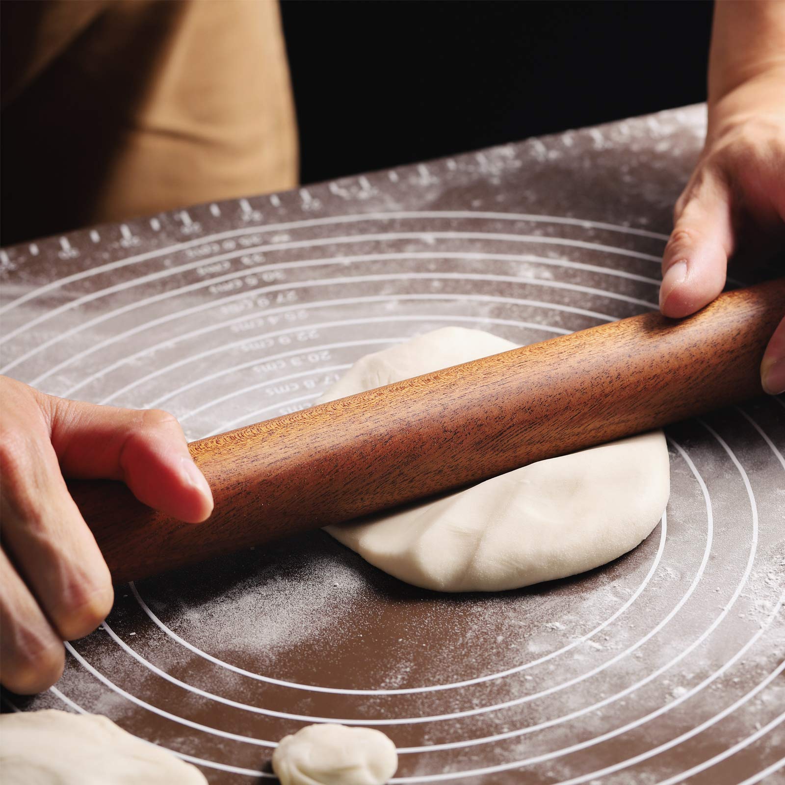 Muso Wood Sapele dowel rolling pin, dough rolling in action for pies or cookies.