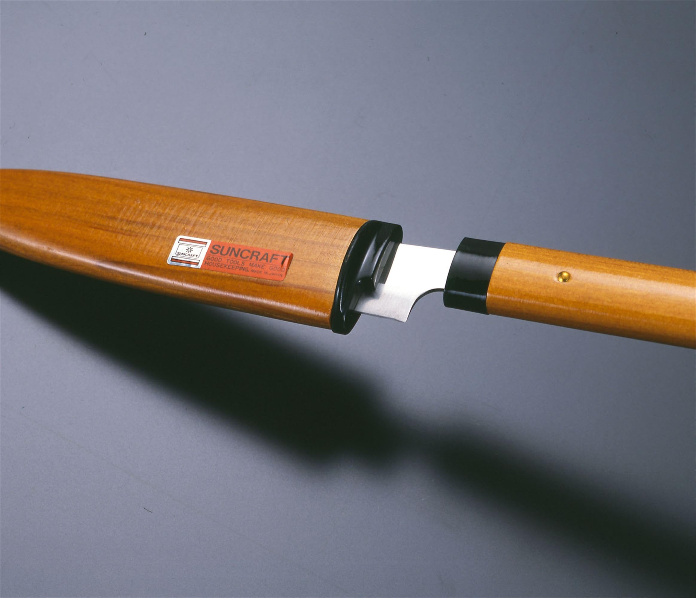 Ergonomic wooden handle provides comfortable grip during prep.