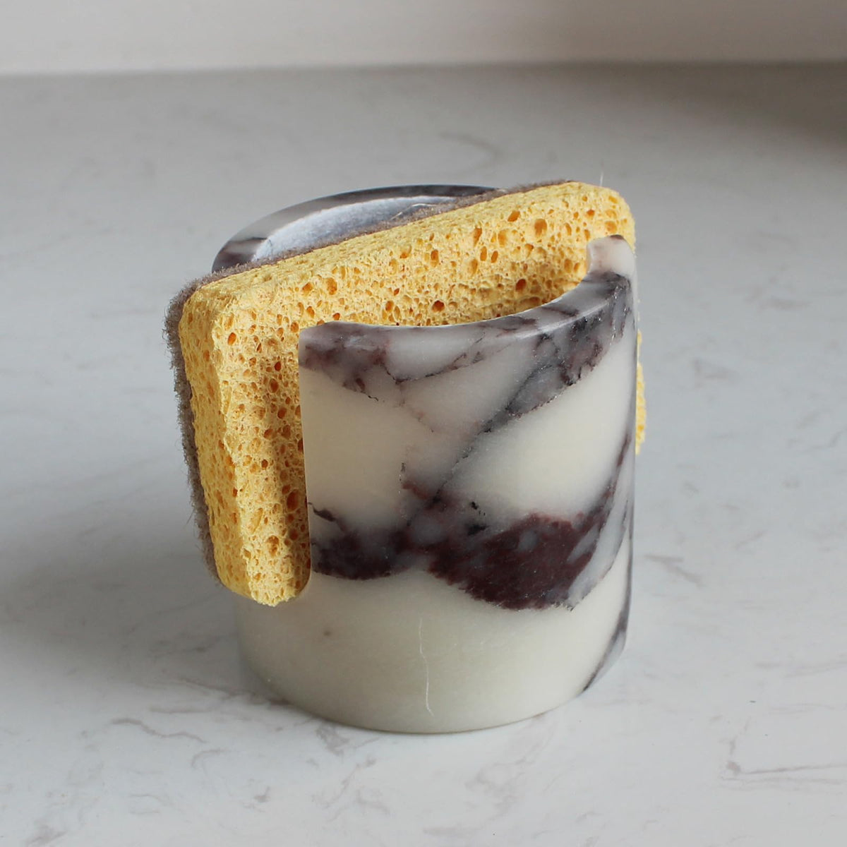Nawgnail Calacatta Viola marble sponge holder on a clean kitchen counter for organized drying
