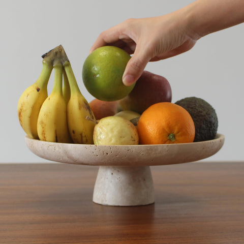 Nawgnail travertine pedestal bowl on counter for fruit and snacks