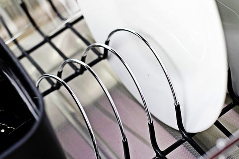 Detachable plastic cutlery cup on the Neat-O drainer for utensils organization.