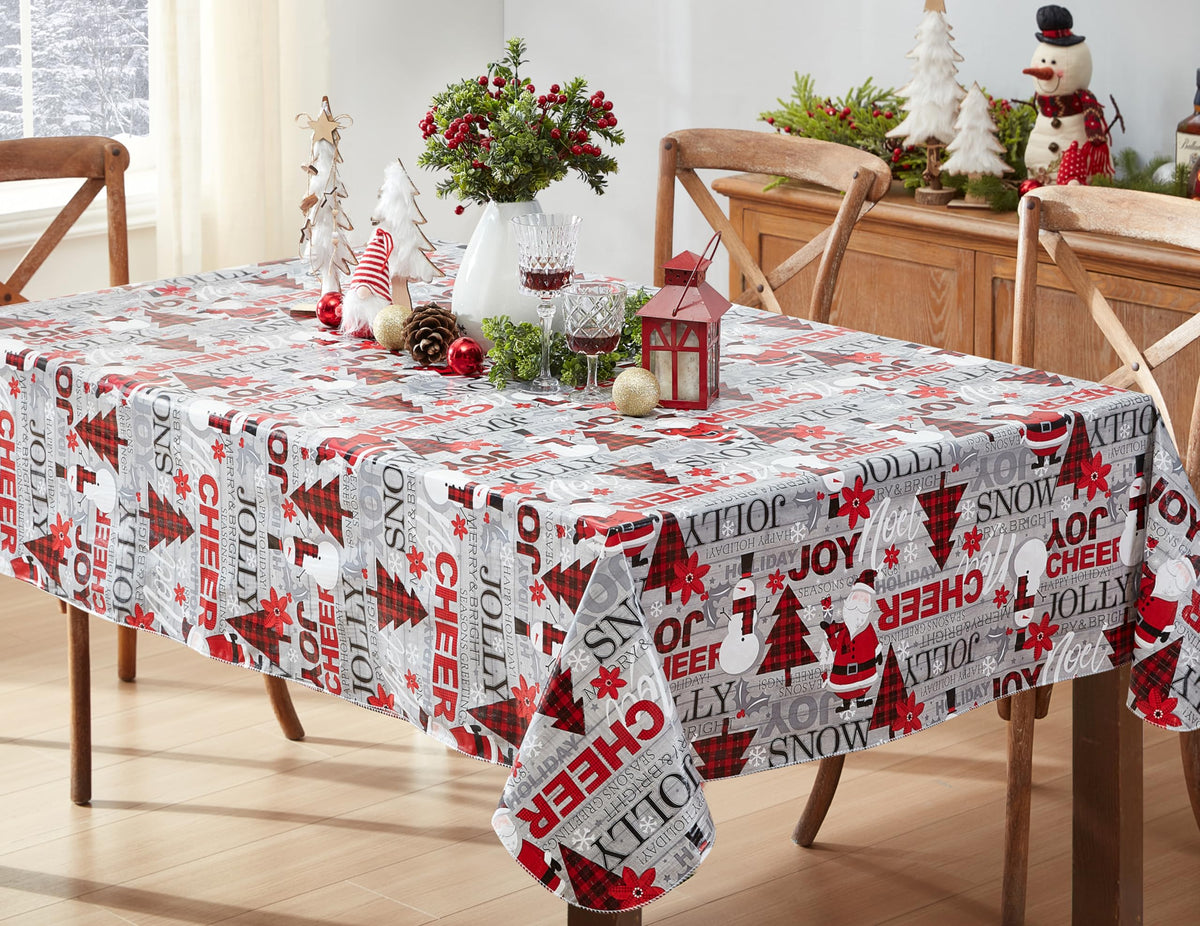 Newbridge Christmas Joy tablecloth on table with Santa print; protects surfaces during holiday meals.
