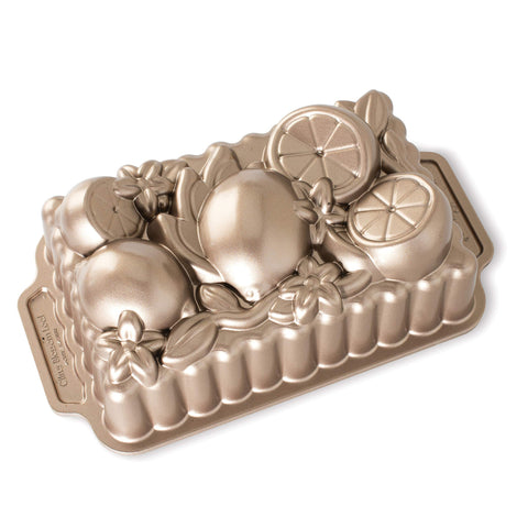 Nordic Ware Citrus Blossom loaf pan side view highlights intricate cast aluminum detail for even browning.