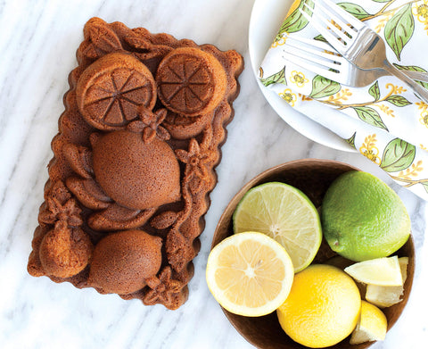 Nordic Ware Citrus Blossom loaf pan top view emphasizes PFAS-free nonstick ease.