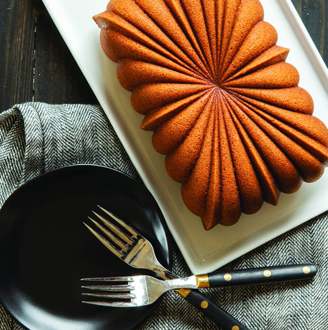 Nordic Ware Classic Fluted Loaf Pan Gold side view shows durable cast aluminum