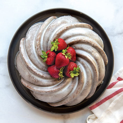 Nordic Ware Swirl Bundt Pan gold, 9.4-inch diameter, 10-cup capacity.