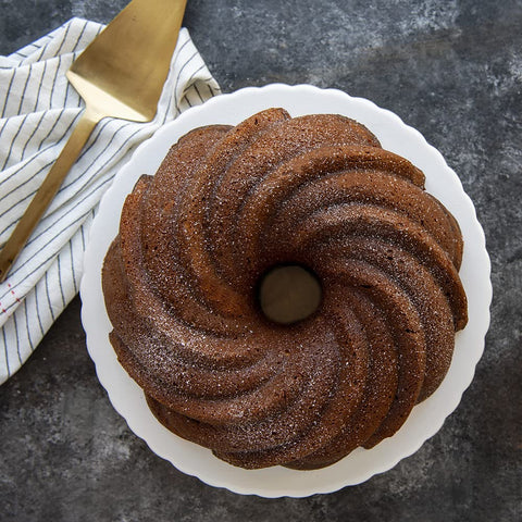 Nordic Ware Swirl Bundt Pan gold, close-up, premium nonstick for quick release.