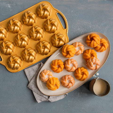 Nordic Ware 95377 Bundtlette Pan gold exterior close-up during baking.